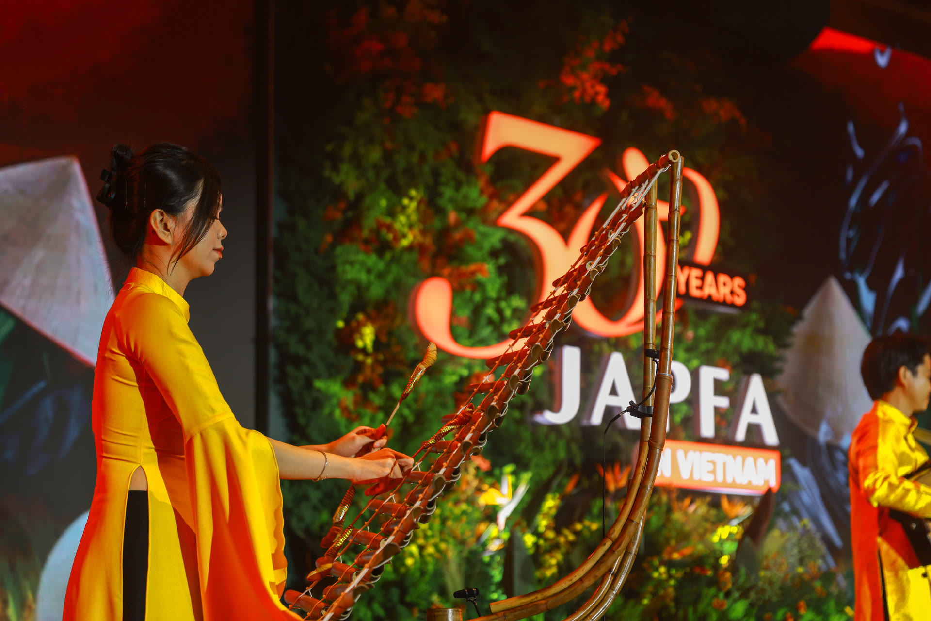 Traditional music beneath the 30 Years marque — heritage at centre stage.
