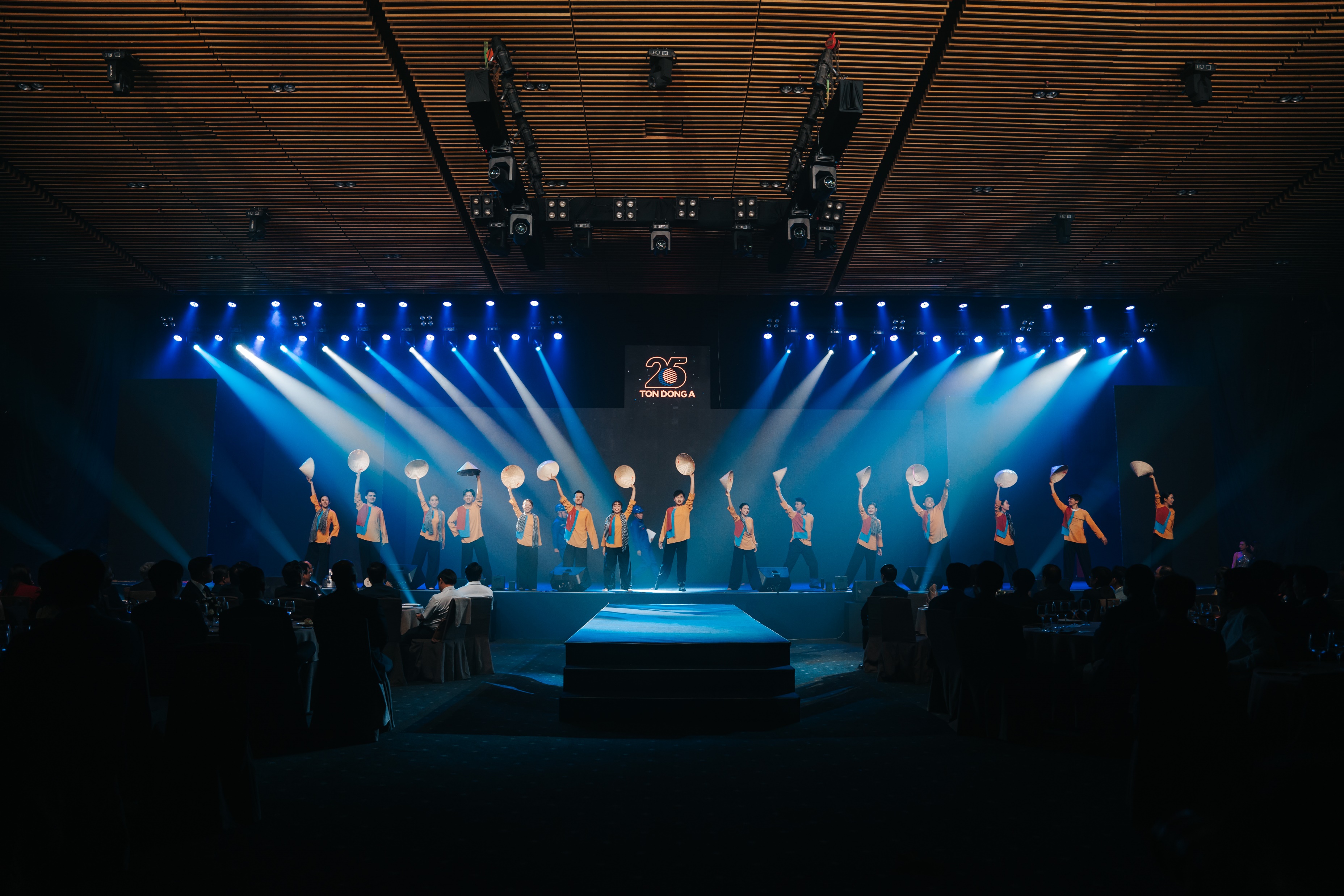 Performers open the ceremony under a wall of light.